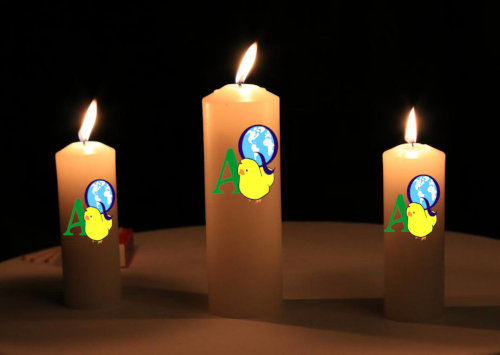 Three burning candles with the AQ logo on each of them